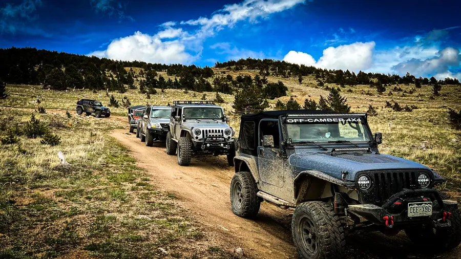 Line of Jeeps on a dirt trail during an Off-Camber club run