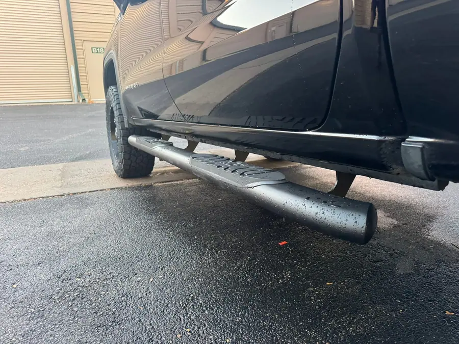 Running boards installed on a lifted truck