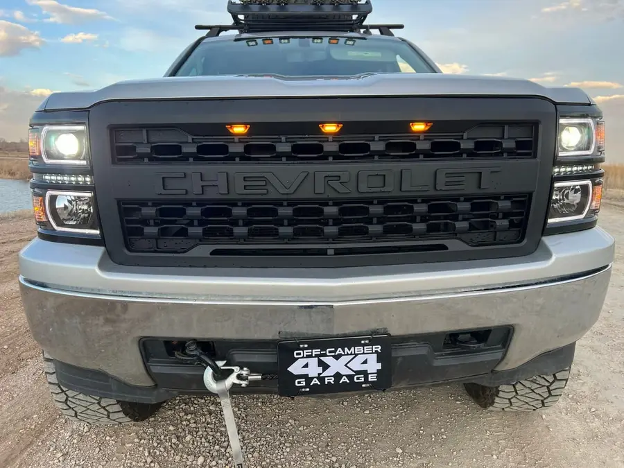 Silverado front end with a blacked-out grille, amber marker lights and winch