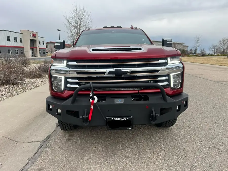 Chevy Silverado HD with a steel winch bumper and red recovery hook