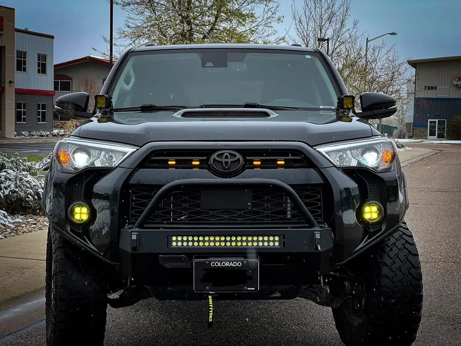 Toyota 4Runner with a steel bumper, light bar and yellow fog pods