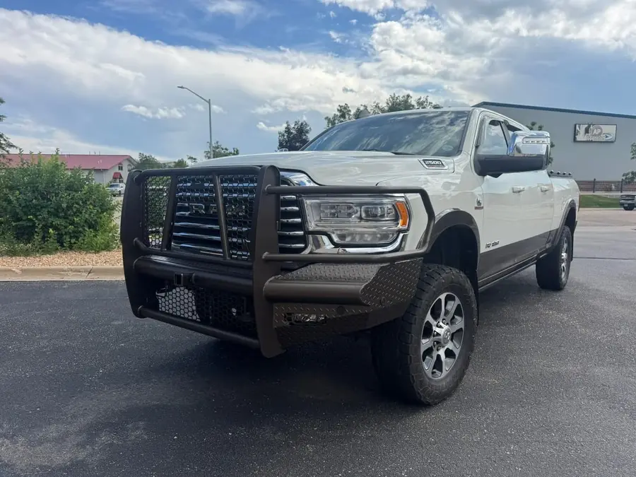 White Ram HD with a black grille guard bumper