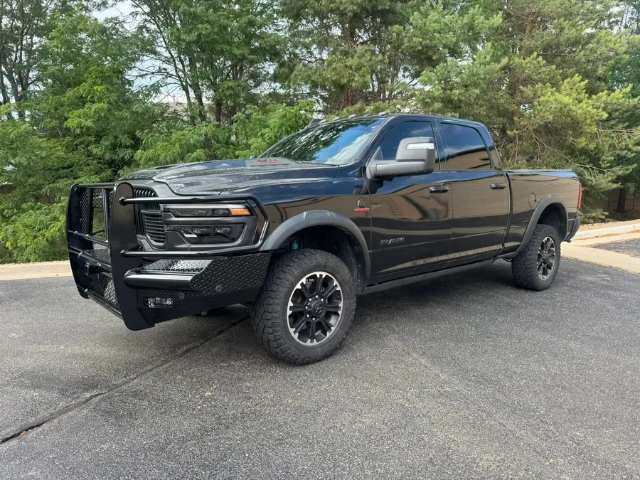 Black Ram HD with a grille guard bumper, front three-quarter view