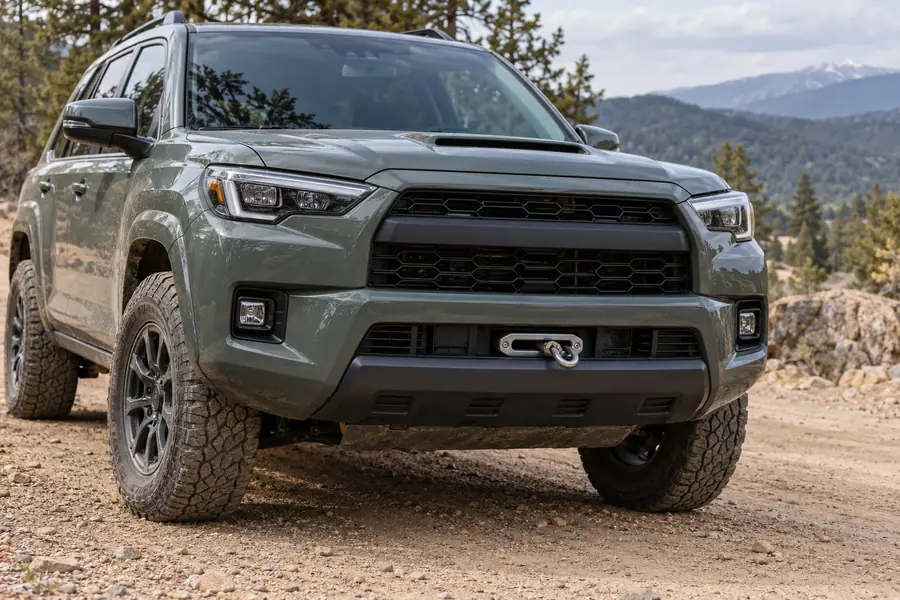 An off-road SUV with a factory-style bumper and a hidden winch, only the fairlead and hook showing