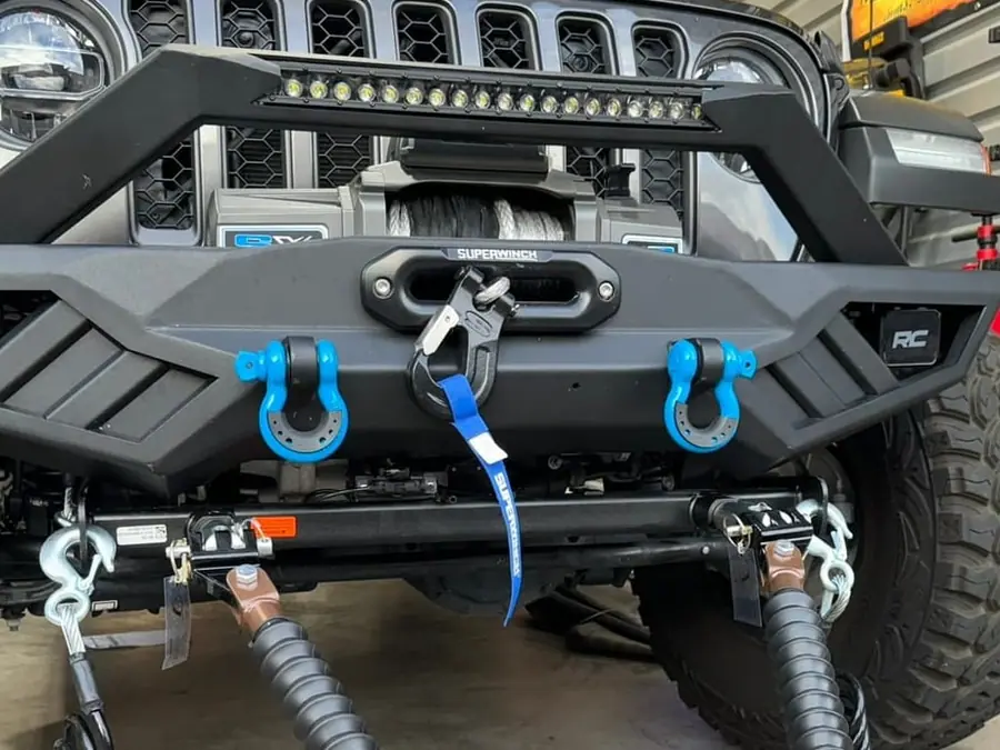 A Jeep Wrangler JL in the Off-Camber shop with synthetic winch rope on the drum, a hawse fairlead and the hook stowed