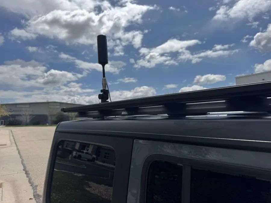 weBoost cell antenna on a folding mount on a Jeep Wrangler roof rack