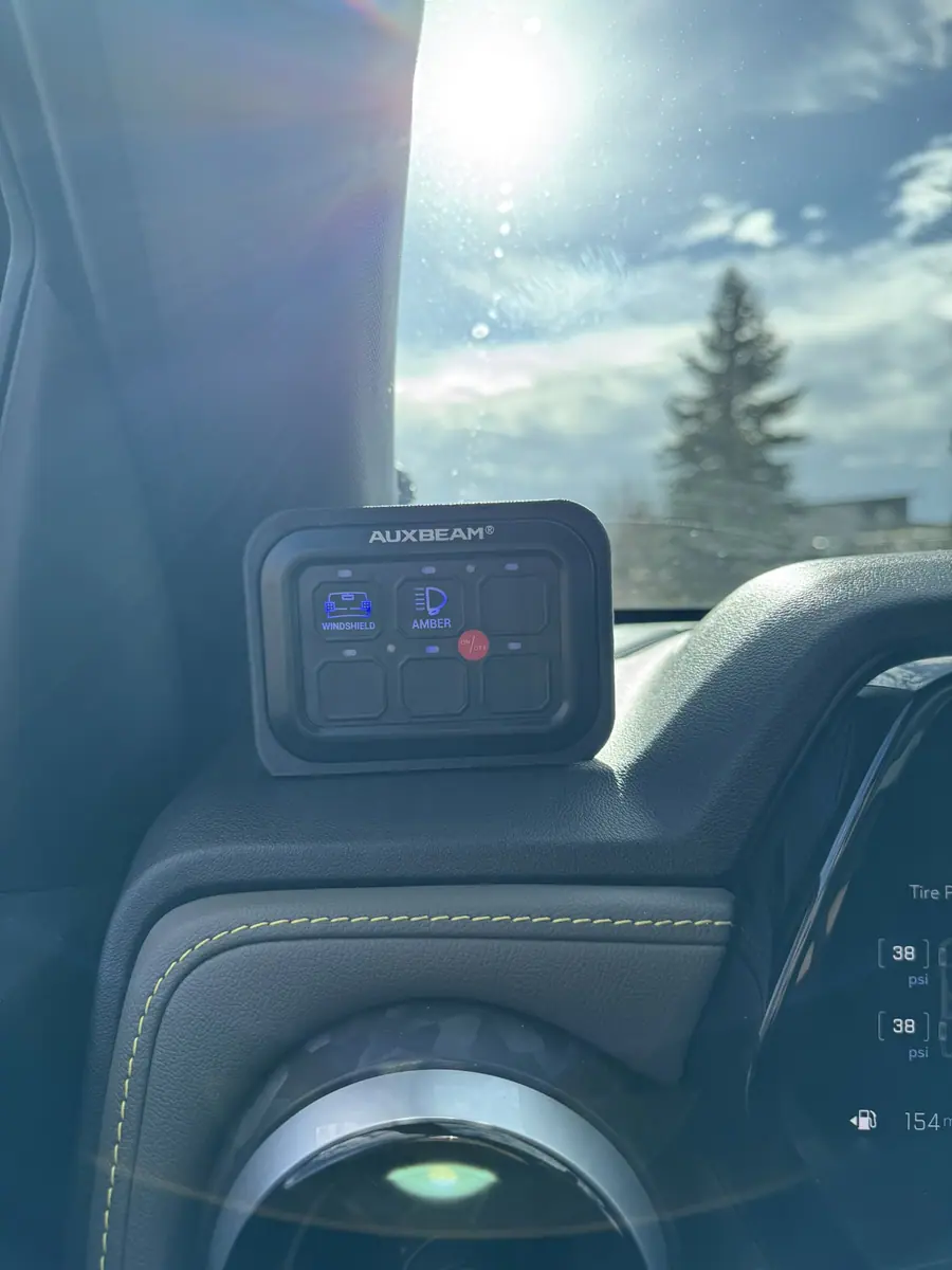 Auxbeam six-button switch panel in a custom dashboard mount in a Chevy Colorado ZR2