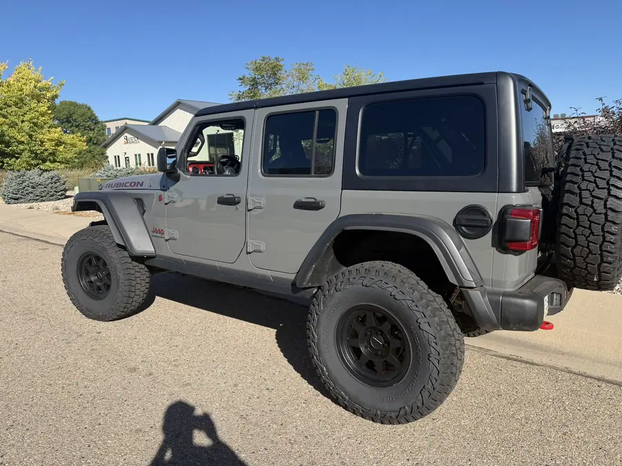 Lifted gray Jeep Wrangler Rubicon Xtreme Recon on 37-inch tires, rear side view