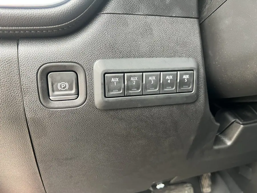 Factory GM AUX 1 through 5 switch bank in the knee panel of a Chevy Silverado 2500HD