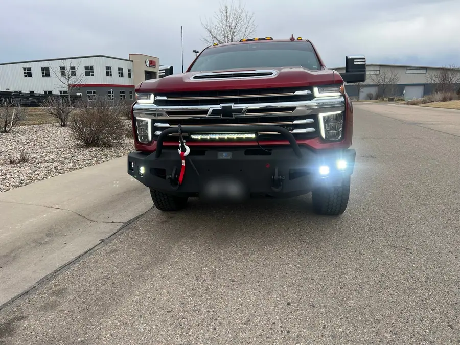 Chevy Silverado 2500HD with its bumper pod lights turned on