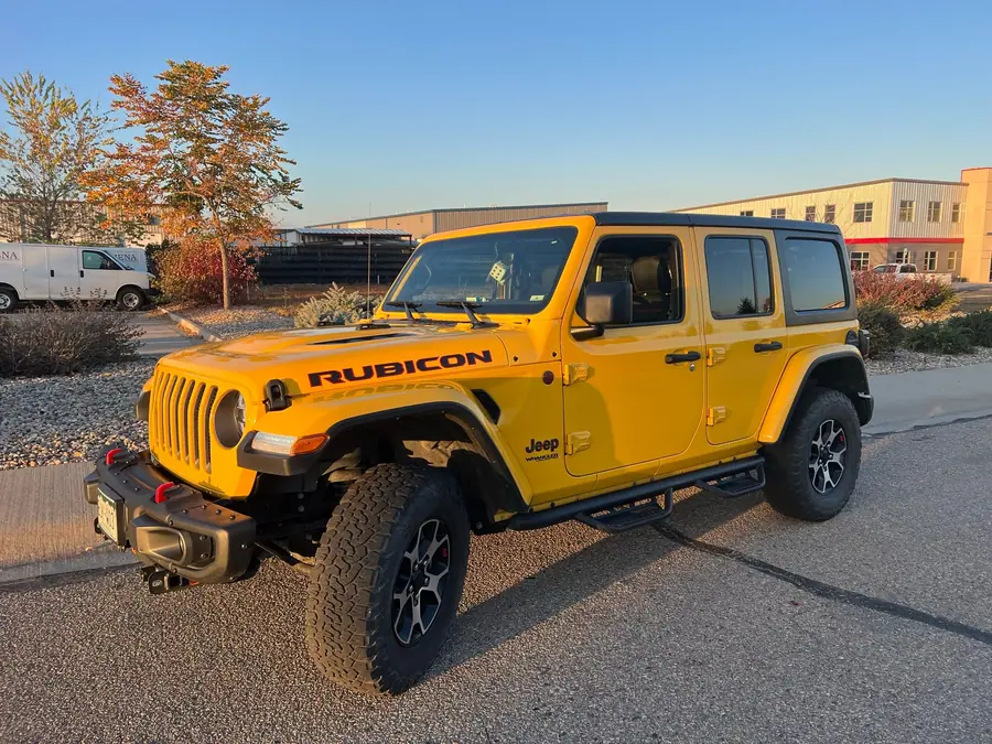 Yellow Jeep Wrangler Rubicon Unlimited at stock height before its lift