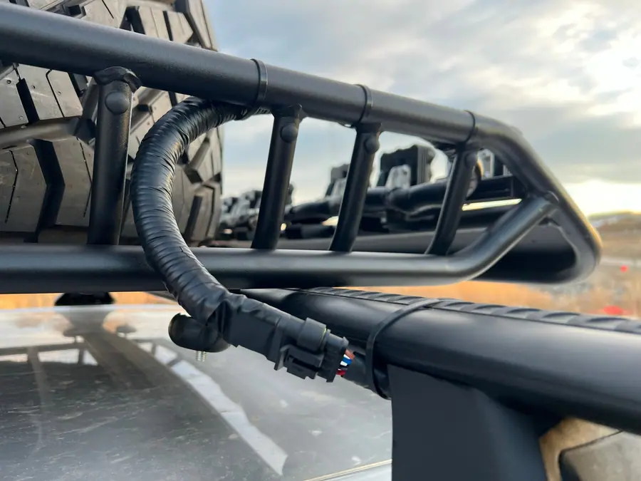 Protective loom over a custom light wiring harness on a truck roof rack