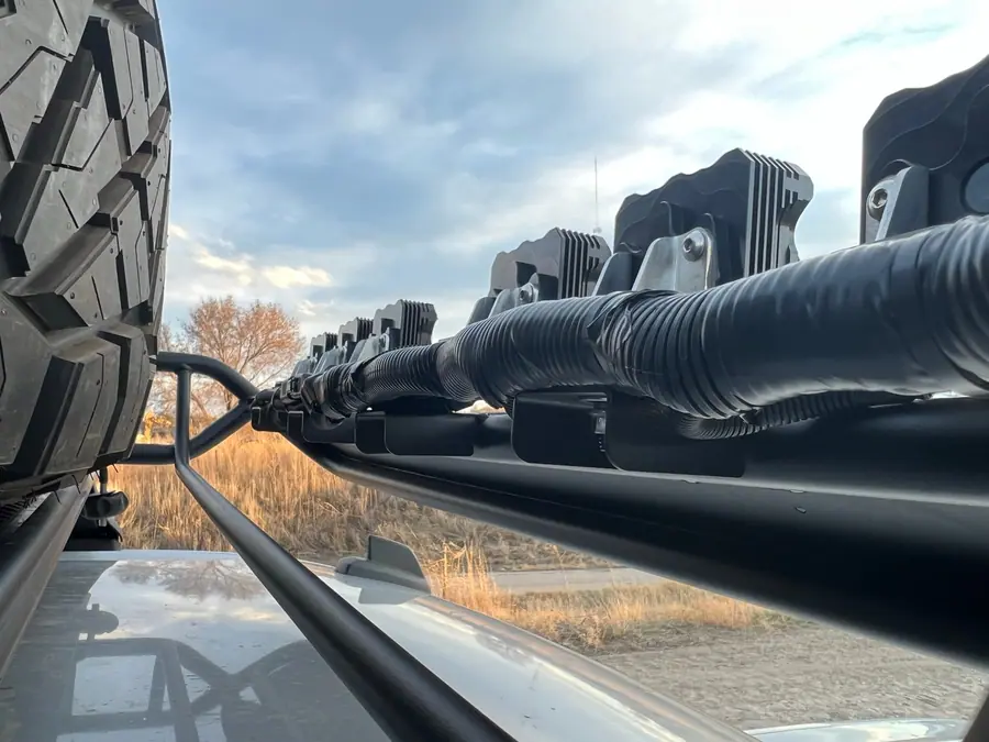 LED pod wiring routed neatly along a truck roof basket