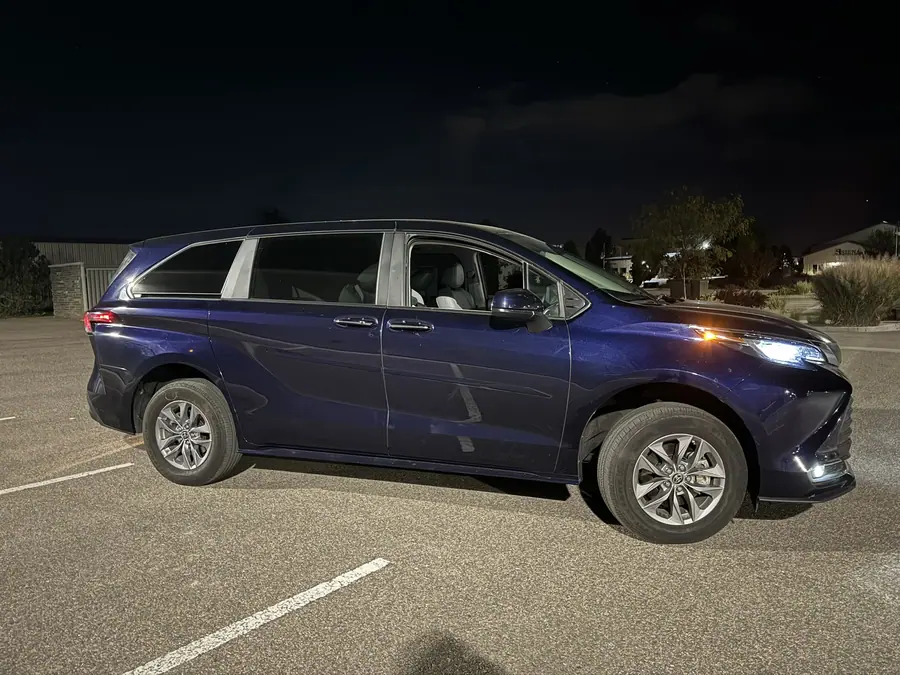 Lifted blue Toyota Sienna minivan, front three-quarter view