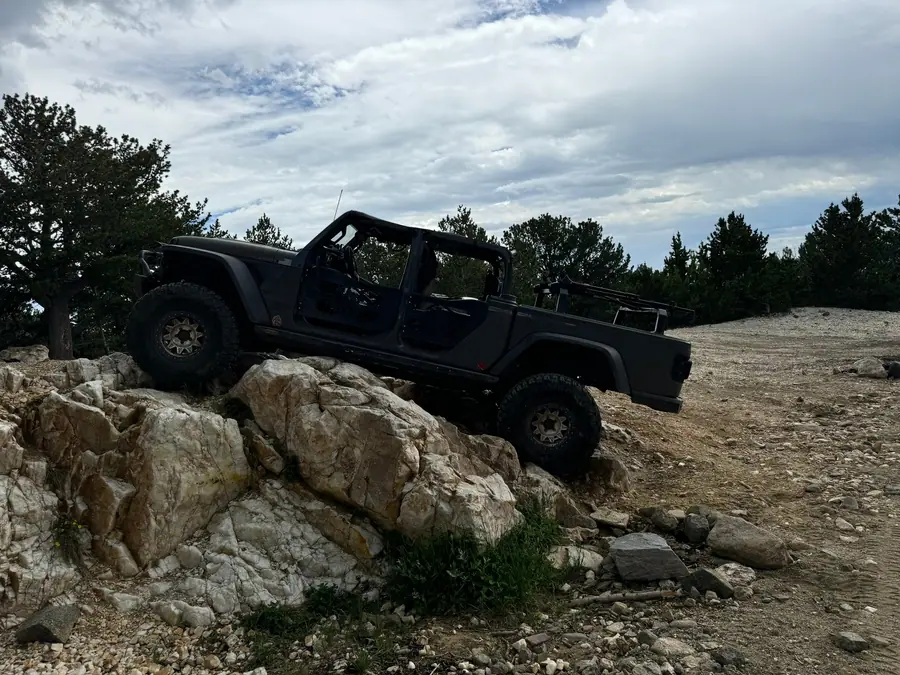 Jeep Gladiator climbing over granite rocks