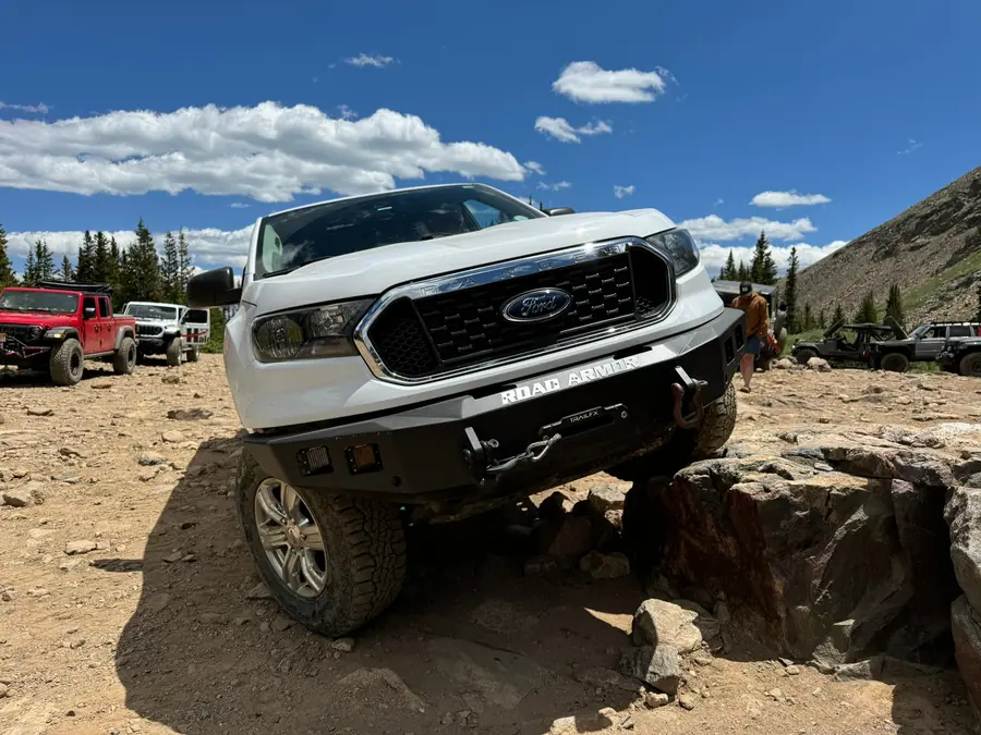 Ford Ranger stepping down a rock ledge on a high alpine trail