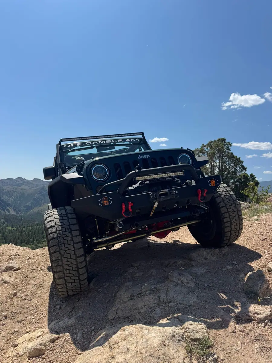 Off-Camber Jeep parked on a rocky summit