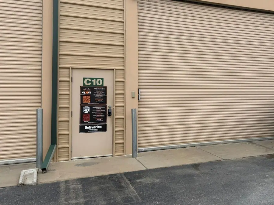 Off-Camber 4x4 Garage entrance: the Unit C10 door with the Off-Camber sign, next to a large roll-up bay door