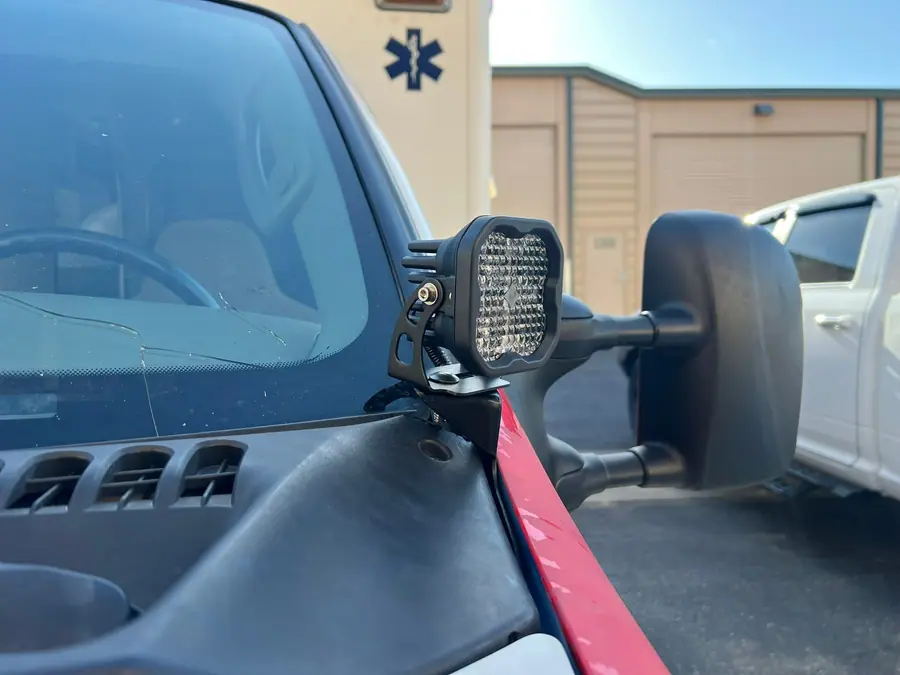 LED pod mounted on a cowl bracket beside the windshield