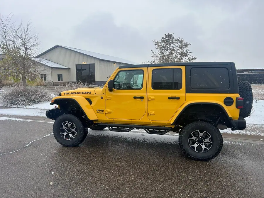 Yellow lifted Jeep Wrangler JL Rubicon