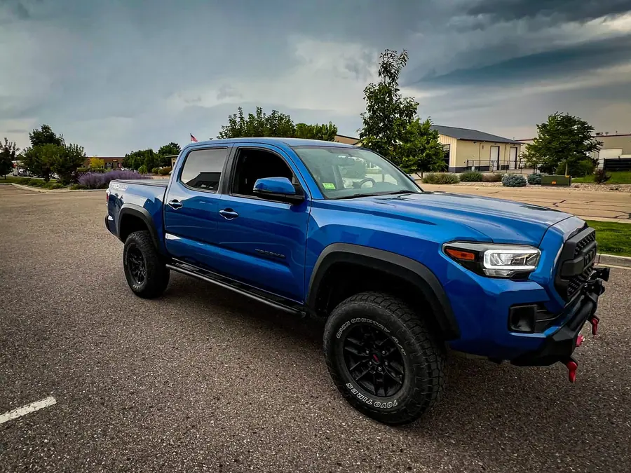 Leveled blue Toyota Tacoma on all-terrain tires