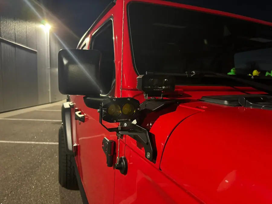 Ditch lights mounted at the windshield of a Jeep