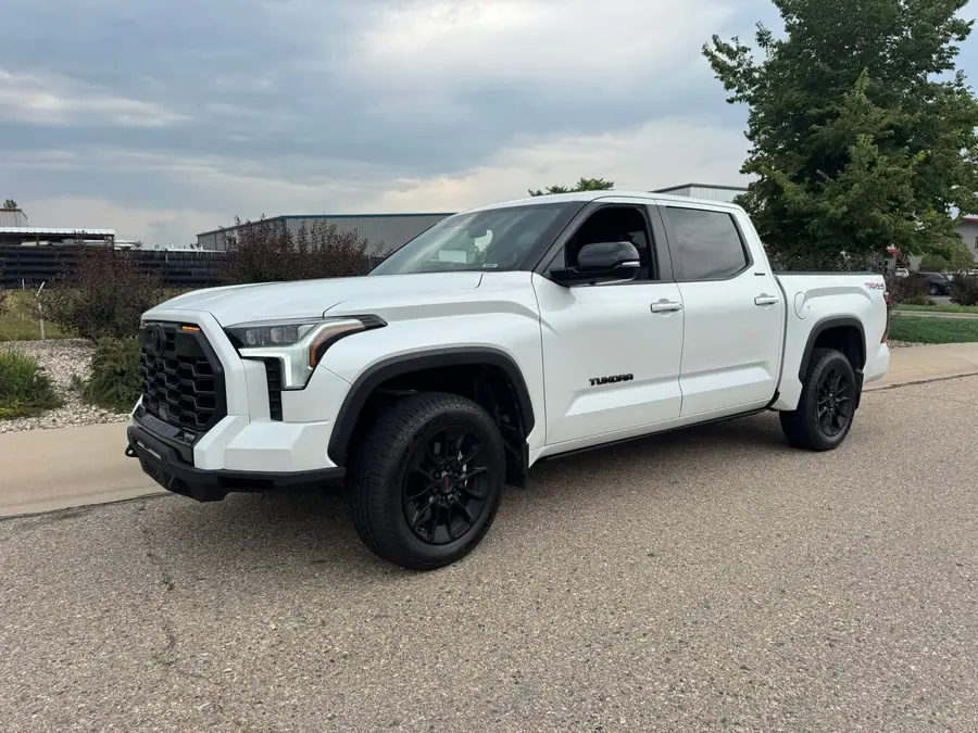 Leveled white Toyota Tundra on aftermarket wheels
