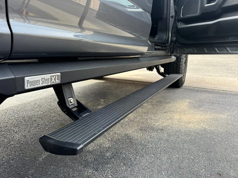 Power running board extended on a lifted truck