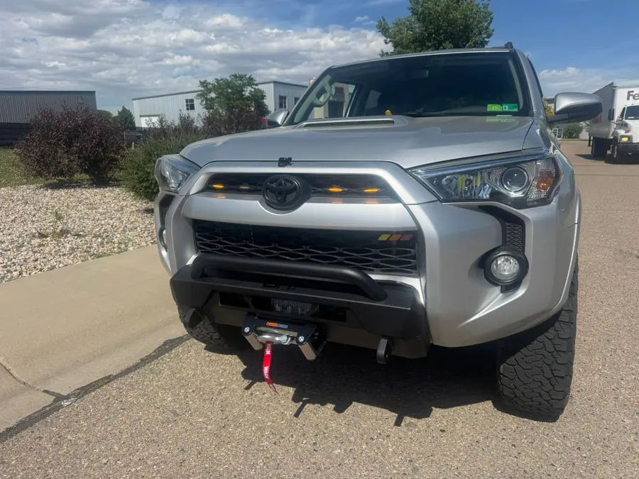 Steel front bumper with a winch on a silver Toyota 4Runner