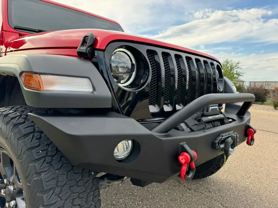 Smittybilt front bumper and winch on a red Jeep Wrangler JL