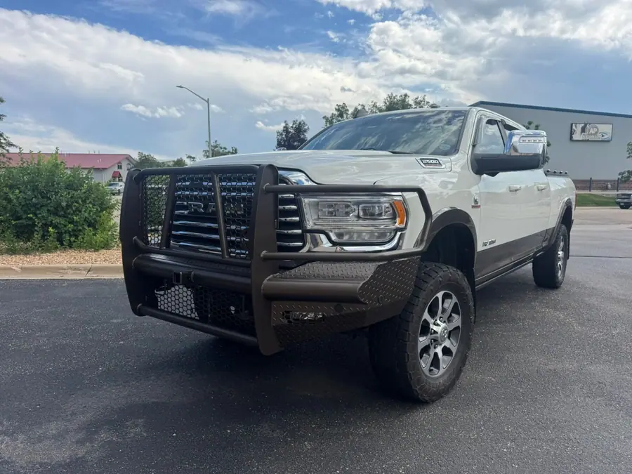 White 2023 Ram 2500 with a Ranch Hand grille guard bumper powder coated to match the lower body trim