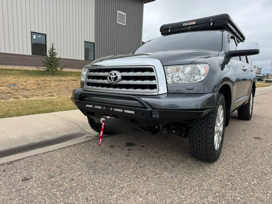 Steel front bumper with a Warn winch on a gray Toyota Sequoia with a roof-top tent