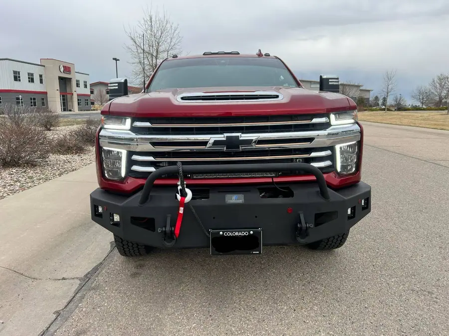 Hammerhead front bumper with a winch on a red Chevy Silverado HD