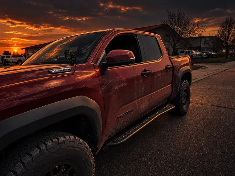 RCI Off Road rock sliders on a red 2024 Toyota Tacoma at sunset