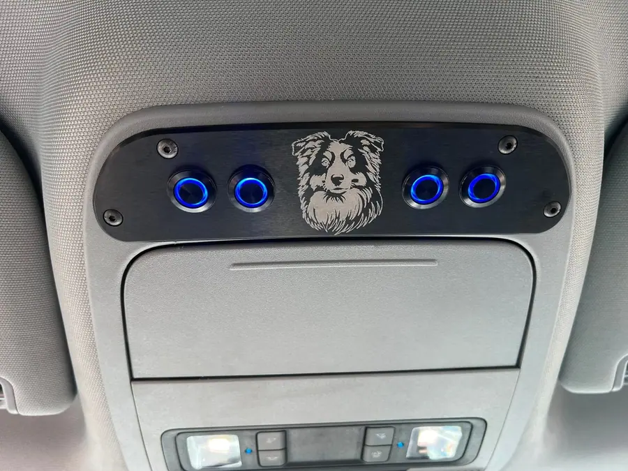 Custom overhead switch console with lit switches in a truck headliner