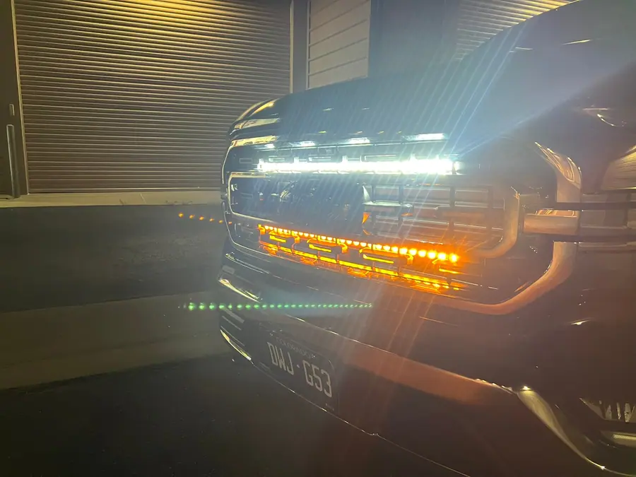 Amber and white LED light bar lit at night