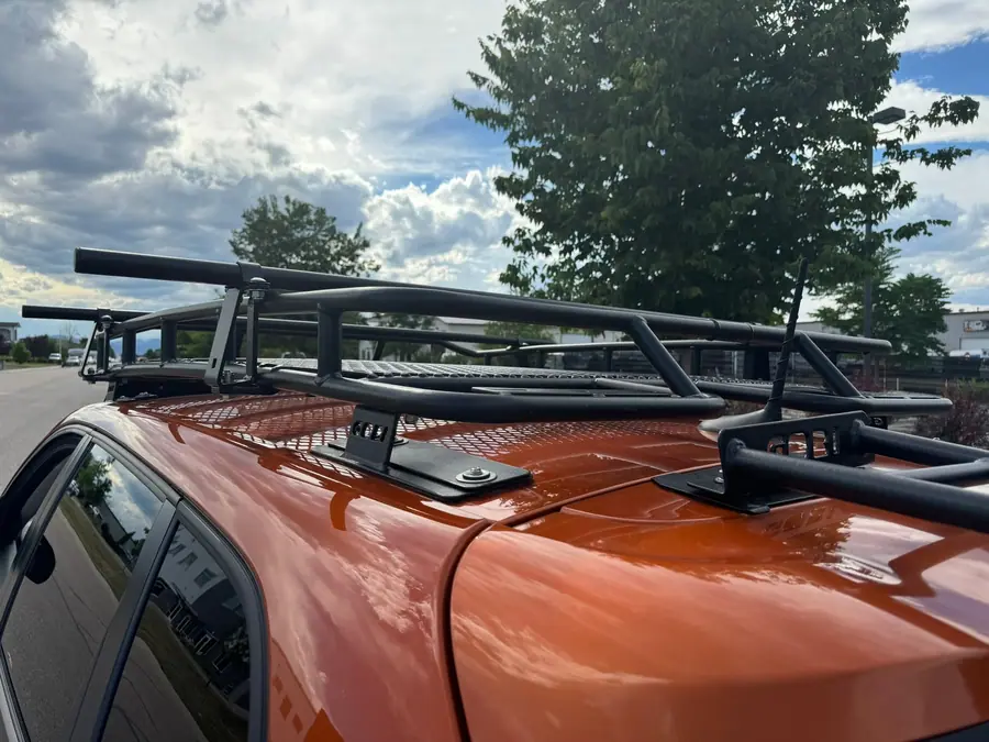 Gobi roof rack and ladder installed on an orange Jeep Cherokee