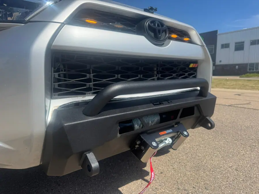 Warn winch with a hawse fairlead on a steel front bumper, silver Toyota 4Runner