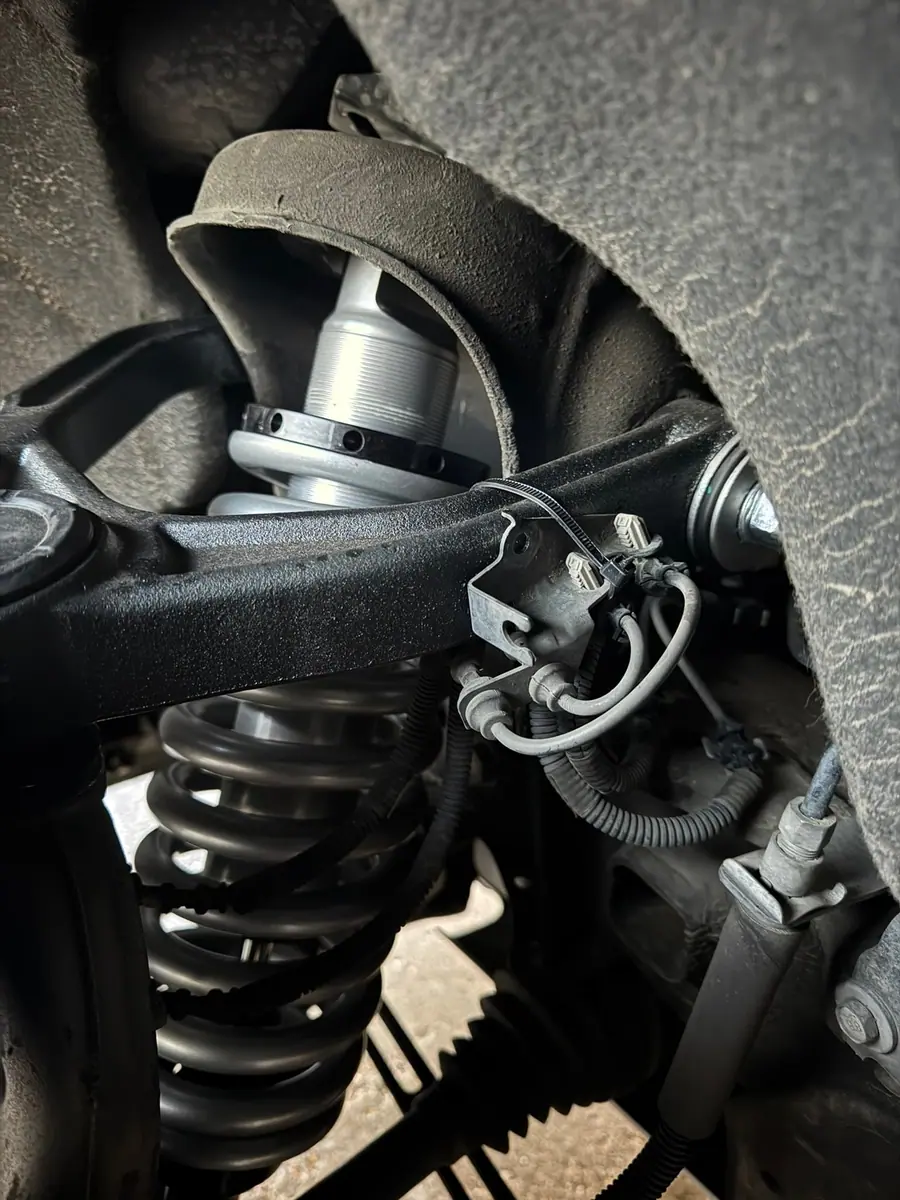 Upper control arm and ball joint on an independent front suspension pickup