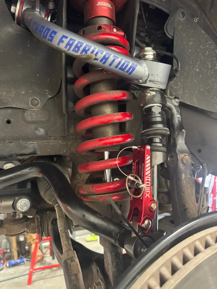 Aftermarket upper control arm, coilover and tie rod on an independent front suspension